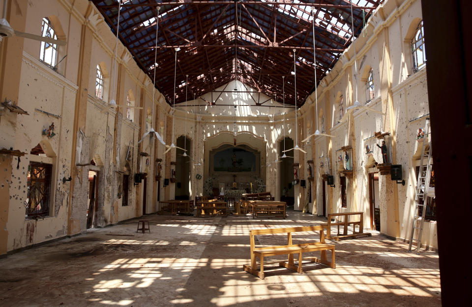 In this Thursday, April 25, 2019 photo, sunlight steams in from gaping holes at St. Sebastian's Church in Negombo, north of Colombo, Sri Lanka. Nearly a week later, the smell of death is everywhere, though the bodies are long gone. Yet somehow, there’s a beauty to St. Sebastian’s, a neighborhood church in a Catholic enclave north of Sri Lanka’s capital, where a man calmly walked in during Easter services with a heavy backpack and blew himself up. (AP Photo/Manish Swarup)