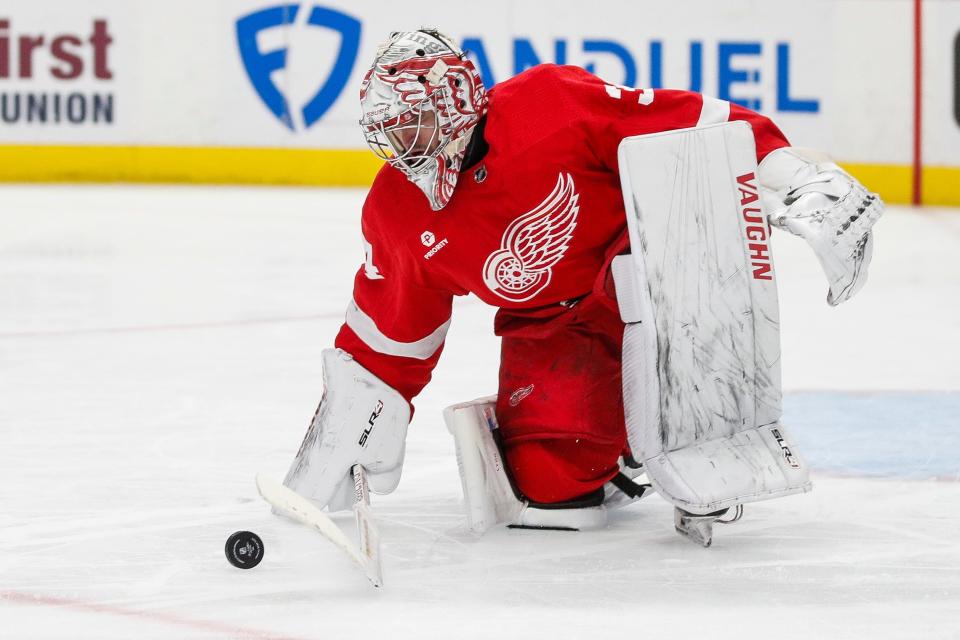 Detroit Red Wings goaltender Alex Lyon (34) stops the puck against Montreal Canadiens during the second period at Little Caesars Arena in Detroit on Monday, April 15, 2024.