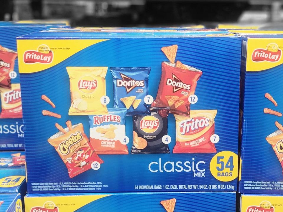 Blue boxes with images of Frito Lay chips including Lay's, Doritos, Cheetos, Ruffles, and Fritos on them