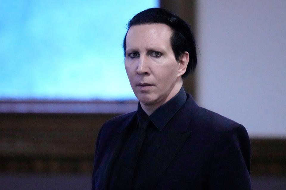 A videographer covering a Marilyn Manson concert in 2019 in New Hampshire says he put his face close to her camera and spit a “big lougee” at her.