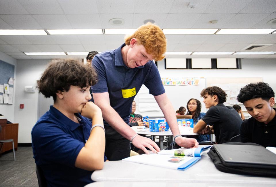 Noah Moon, CEO of CRAM or Creating Role Models and Mentors, works with Fort Myers Middle Academy student David Perez during an after-school session at the school in March. Noah plans on continuing the program once his brother goes to college. The program is also expanding to other Lee County schools.