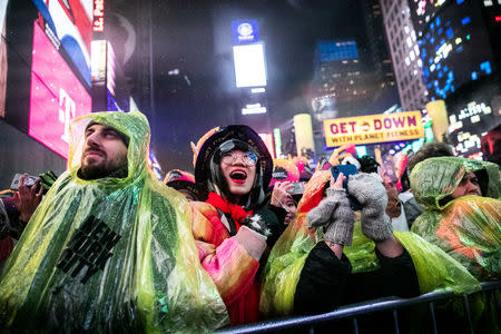 Revelers celebrate New Year's Eve in Times Square, in the Manhattan borough of New York, U.S., December 31, 2018. REUTERS/Jeenah Moon