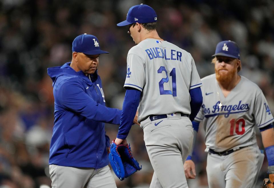 Manager Dave Roberts takes the ball from Walker Buehler during the Dodgers' loss to the Rockies on Wednesday.