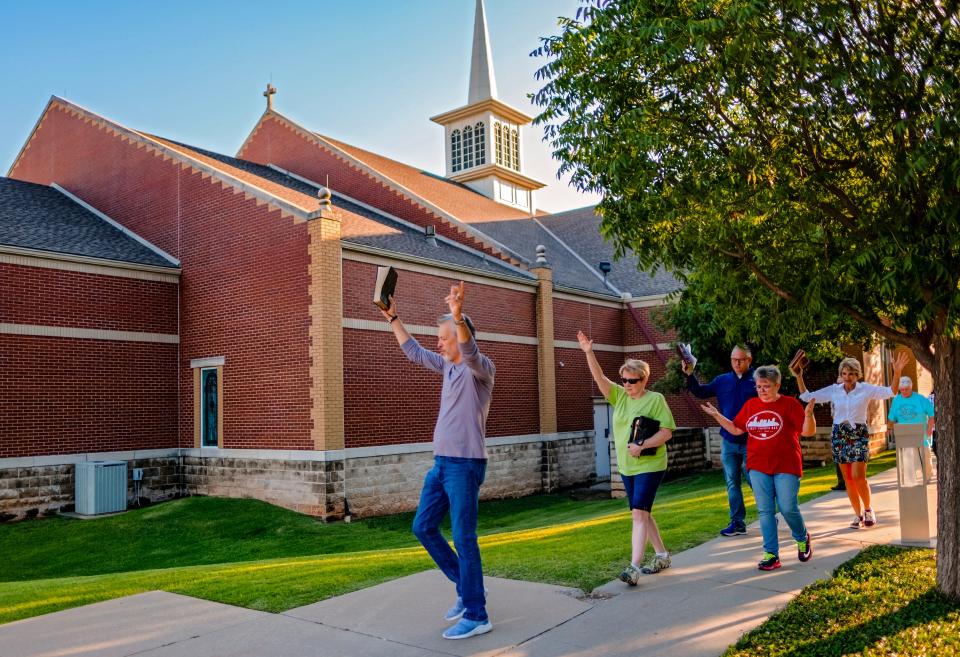 First United Methodist Church of Oklahoma City members and supporters pray as they walk around the First Church building at the corner of NW 4 and Robinson on Thursday in downtown Oklahoma City.