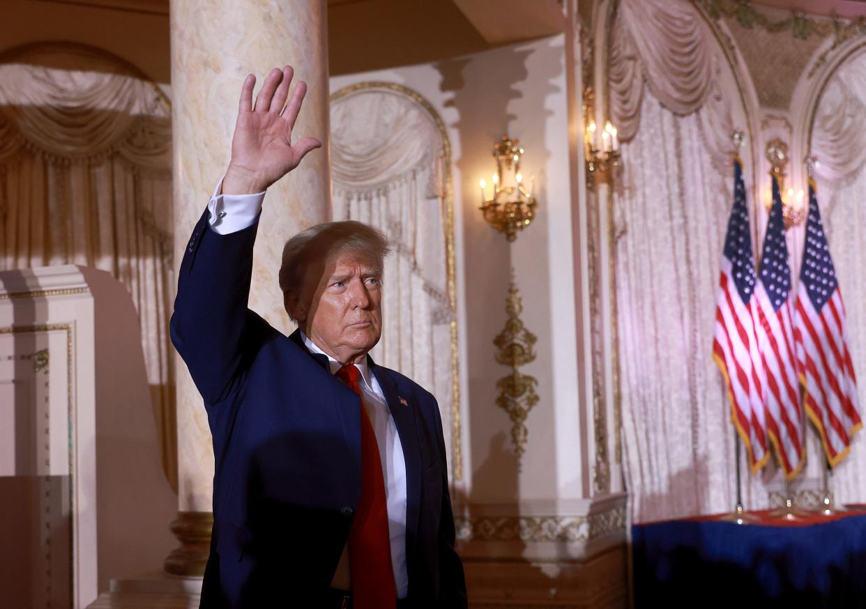 Donald Trump waving with his right arm after announcing a presidential run.