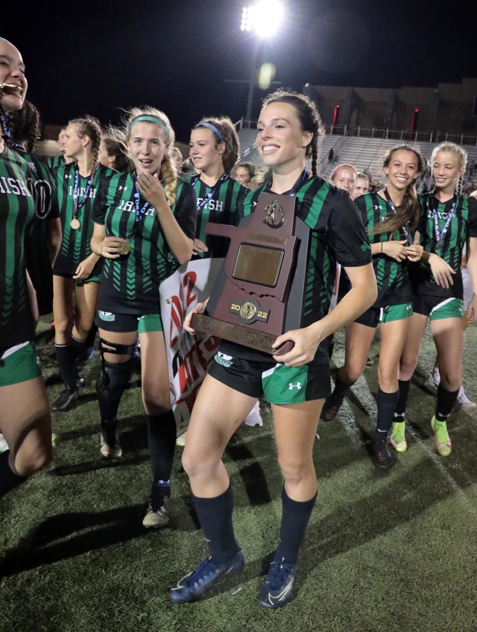 Bishop McGuinness players celebrate May 13, 2022, as they defeat Piedmont in the Class 5A high school state girls soccer finals at Taft Stadium School in Oklahoma City.