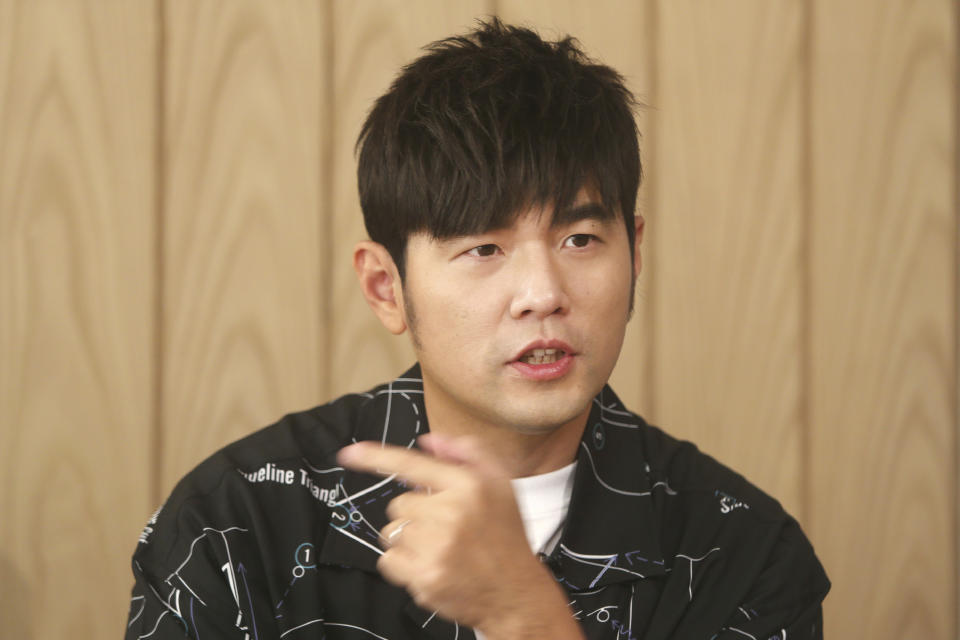 In this Sunday, April 26, 2020, photo, Mandopop superstar Jay Chou talks about his latest Netflix show "J-Style Trip" and life with his children during an interview with The Associated Press in Taipei, Taiwan. (AP Photo/Chiang Ying-ying)