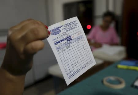 A laundry clerk shows the ticket in which Tonya Couch wrote a false name, during her stay with her son Ethan Couch, 18, in the Pacific beach resort of Puerto Vallarta, Mexico December 29, 2015. REUTERS/Heny Romero