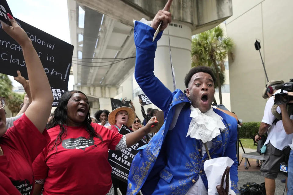 Jonathan Gartwell and others chant outside Miami-Dade School Board headquarters Aug. 16. They were protesting new Florida standards for teaching black history, including slavery.