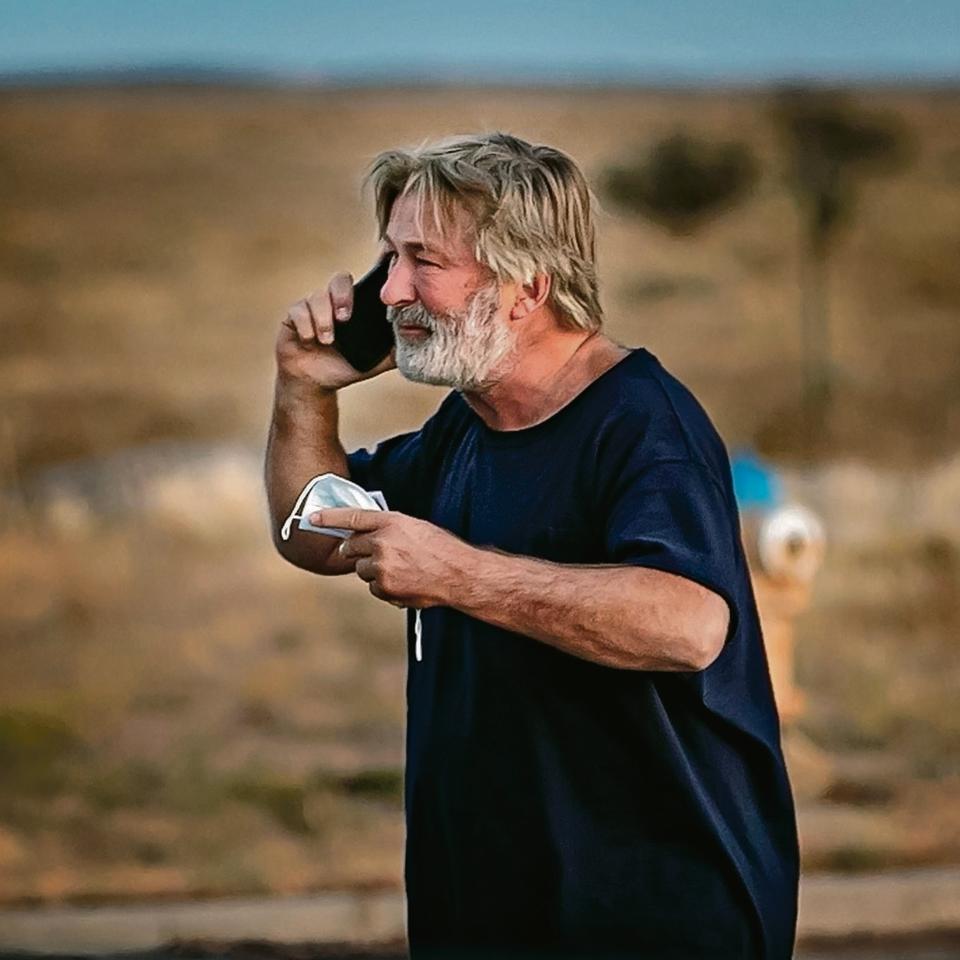 Image: Alec Baldwin takes a call in the parking lot outside the sheriff's offices. (Jim Weber / The New Mexican)