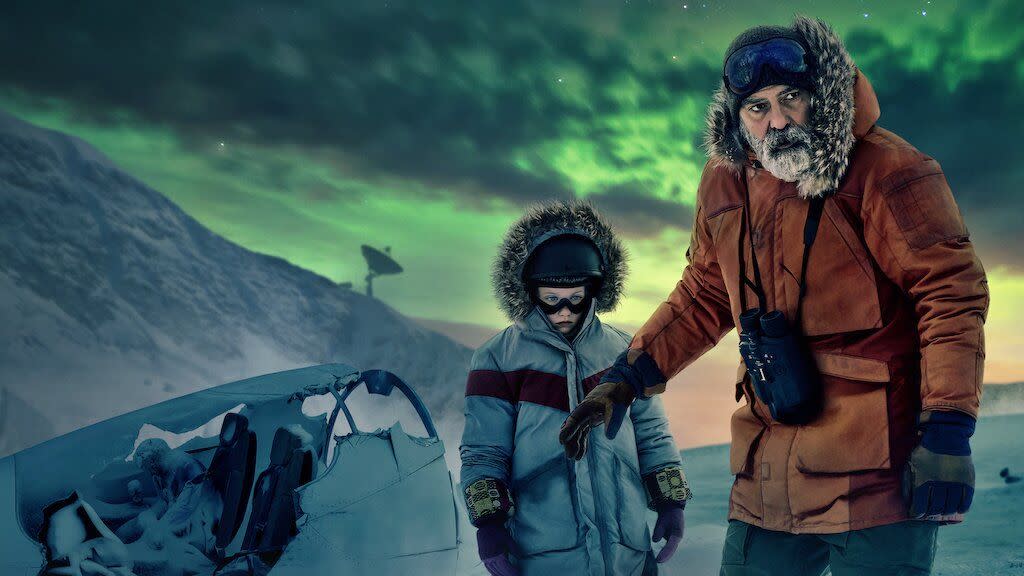 an adult scientist stands with a child against the northern lights in a scene from the midnight sky, a good housekeeping pick for best sad movies on netflix