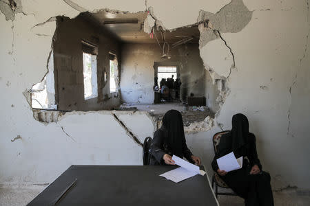 Women wait to be examined in a hospital in Douma, outside Damascus, Syria, September 17, 2018. REUTERS/Marko Djurica/Files