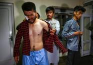 The men say they were punched and beaten with batons, electrical cables and whips after being accused of organising the protest (AFP/Wakil KOHSAR)