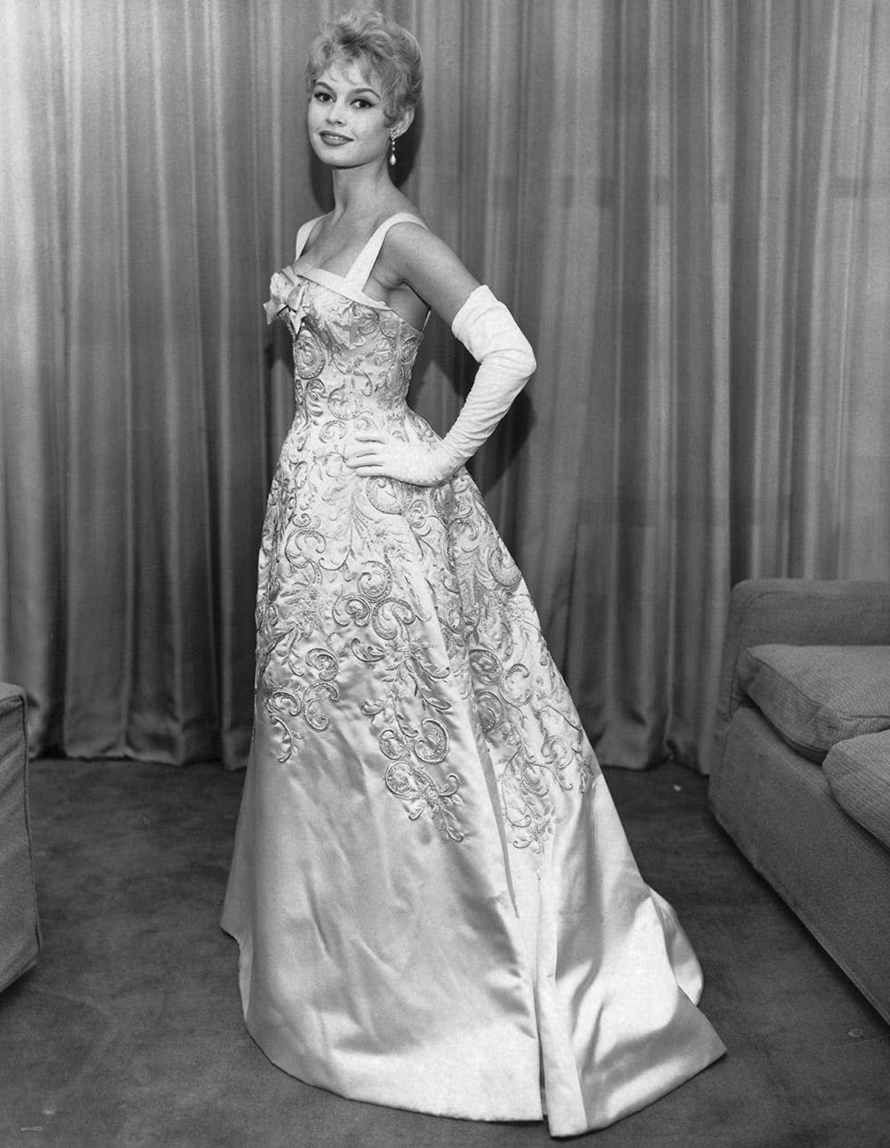 Brigitte Bardot posing in a glamorous gown.