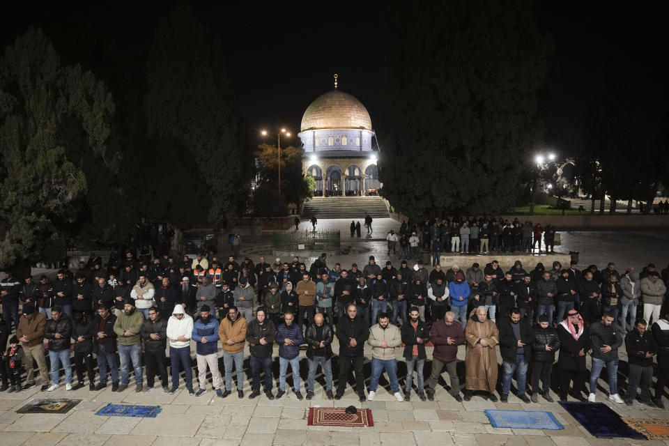 Muslim worshippers perform "tarawih," an extra lengthy prayer held during the Muslim holy month of Ramadan, next to the Dome of Rock at the Al-Aqsa Mosque compound in the Old City of Jerusalem, Sunday, March 10, 2024. Officials in Saudi Arabia have declared the start of the fasting month of Ramadan after sighting the crescent moon Sunday night. The announcement marks the beginning of Ramadan for many of the world's 1.8 billion Muslims. (AP Photo/Mahmoud Illean)