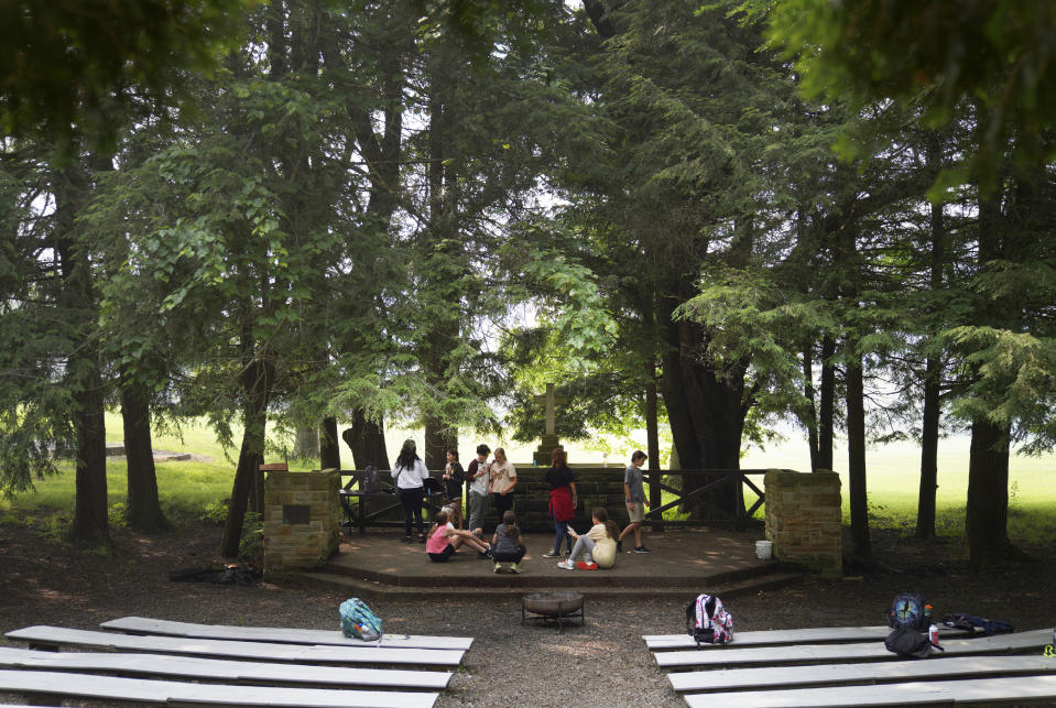 Campers play a game of charades under a canopy of trees at the YMCA Camp Kon-O-Kwee Spencer on Thursday, June 29, 2023, in Zelienople, Pa. Due to the poor air quality caused by the Canadian wildfires the Western Pennsylvania summer camp closed its outdoor pool and sent home a few campers with health problems. (AP Photo/Jessie Wardarski)