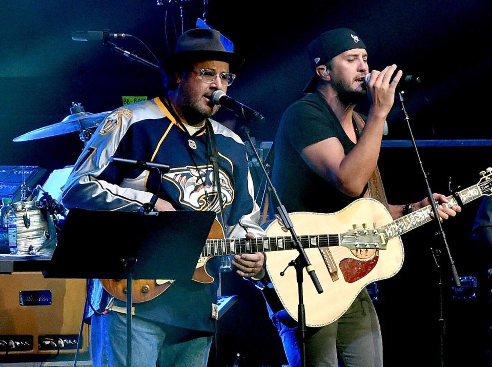 Vince Gill (L) and Luke Bryan perform durring All For The Hall at the Bridgestone Arena on April 12, 2016 in Nashville, Tennessee.