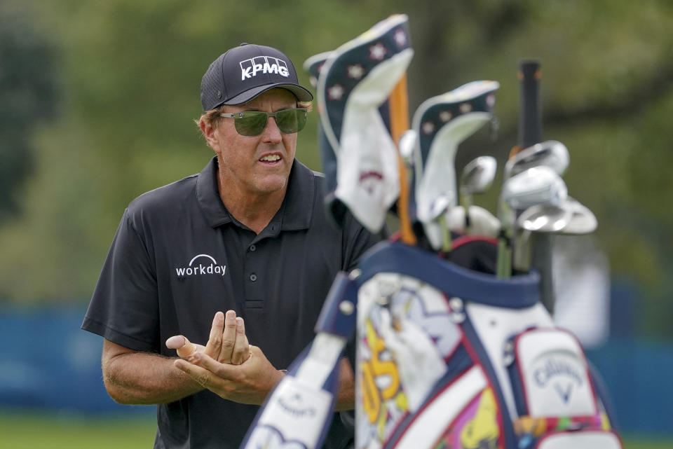 Phil Mickelson, of the United States, rubs sanitizer on his hands before teeing off on the third hole during the first round of the US Open Golf Championship, Thursday, Sept. 17, 2020, in Mamaroneck, N.Y. (AP Photo/John Minchillo)