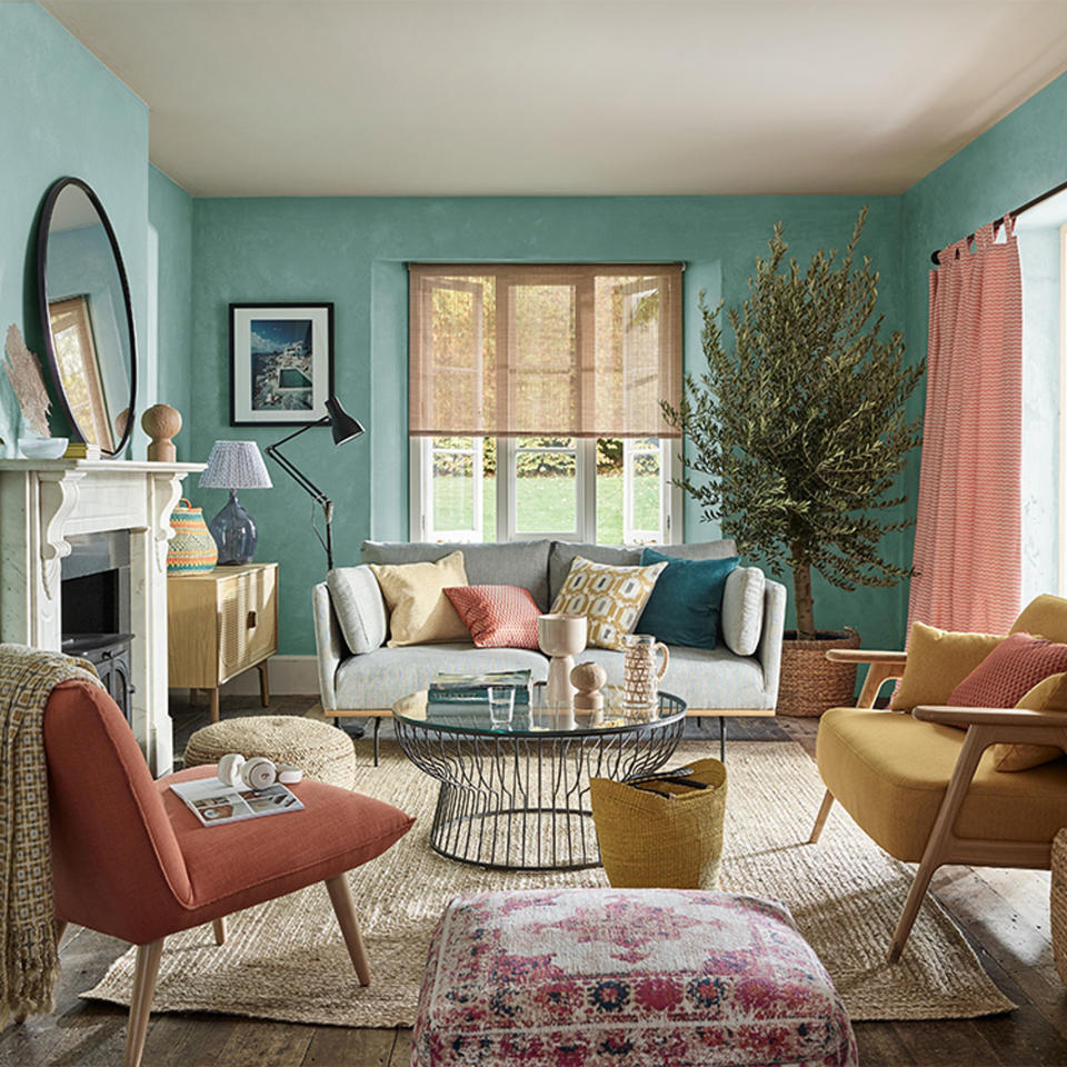 Small living room with green walls and pink curtains