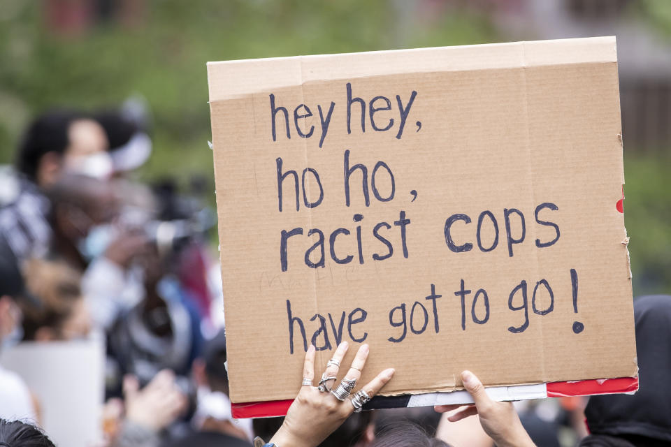 A protester holds a sign that says, "Hey hey, ho ho, racist cops have got to go!" in Manhattan's Foley Square in New York City on June 2, 2020. (Photo: Ira L. Black - Corbis via Getty Images)