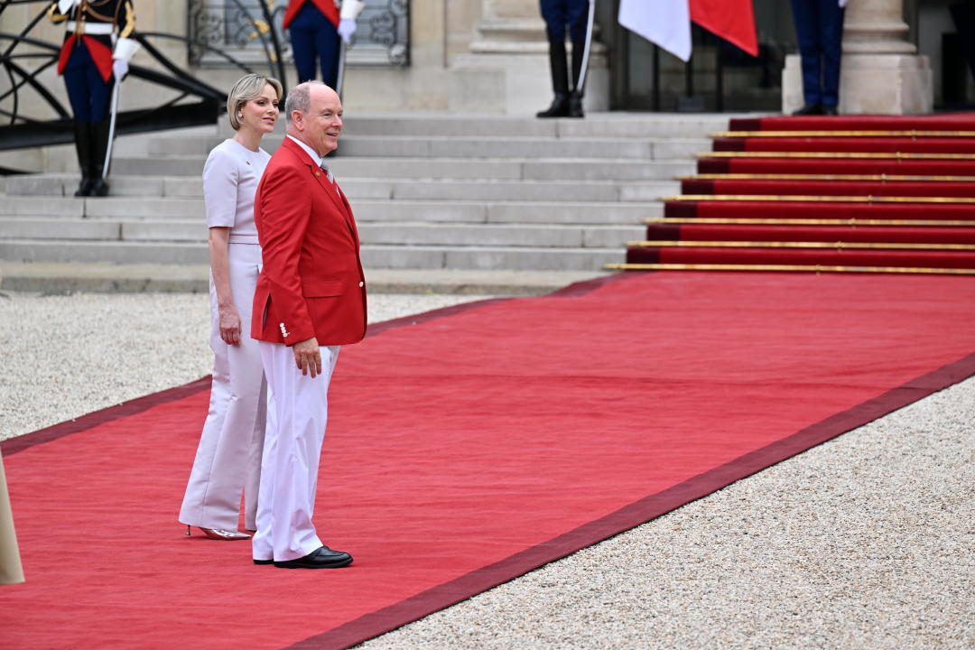 PARIS, FRANCE - JULY 26: France's President Emmanuel Macron (not seen) and his wife Brigitte Macron (not seen) greet Monaco's Prince Albert II and his wife Princess Charlene of Monaco on arrival ahead of a reception for heads of state and governments ahead of the opening ceremony of the Paris 2024 Olympic Games, at the Elysee presidential palace in Paris, on July 26, 2024. (Photo by Mustafa Yalcin/Anadolu via Getty Images)