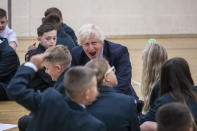 Prime Minister Boris Johnson in the gym taking part in a getting to know you induction session with year sevens as he tours Castle Rock school, Coalville, in the east Midlands.