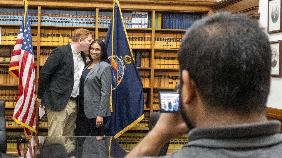 Matt Kleinmann kisses his wife, Sangeeta Shastry, after filing for office on May 20, 2024, at the Secretary of State's Office.