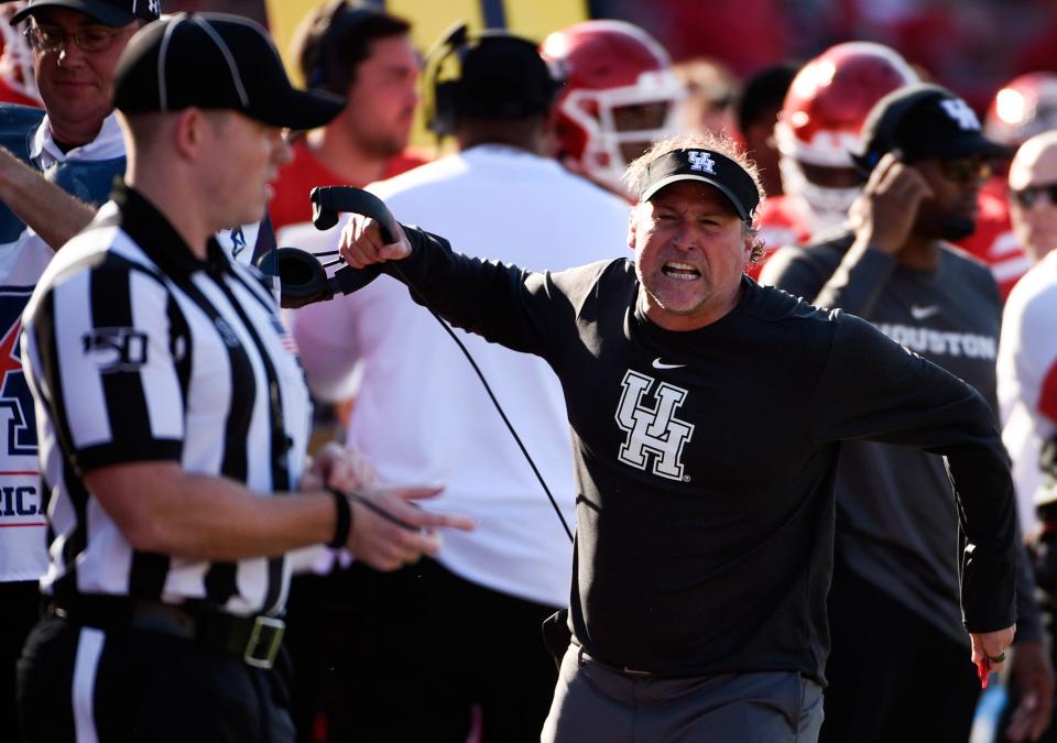 Houston head coach Dana Holgorsen, right, yells at an official during the second half of an NCAA college football game against Cincinnati, Saturday, Oct. 12, 2019, in Houston. (AP Photo/Eric Christian Smith)