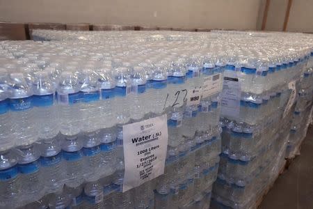 Stacks of bottled water are held at the Food Bank of Eastern Michigan warehouse and will be distributed to the public, after elevated lead levels were found in the city's water, in Flint, Michigan, December 16, 2015. REUTERS/Rebecca Cook