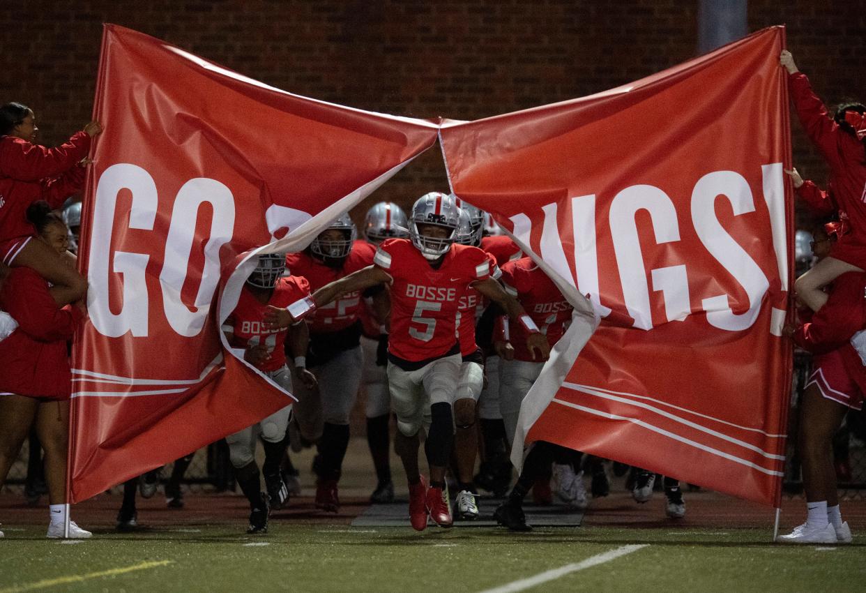 Bosse’s Elijah Wagner (5) leads the Bosse Bulldogs to the field ahead of their game against the Harrison Warriors at Enlow Field in Evansville, Ind., Friday, Oct. 13, 2023.