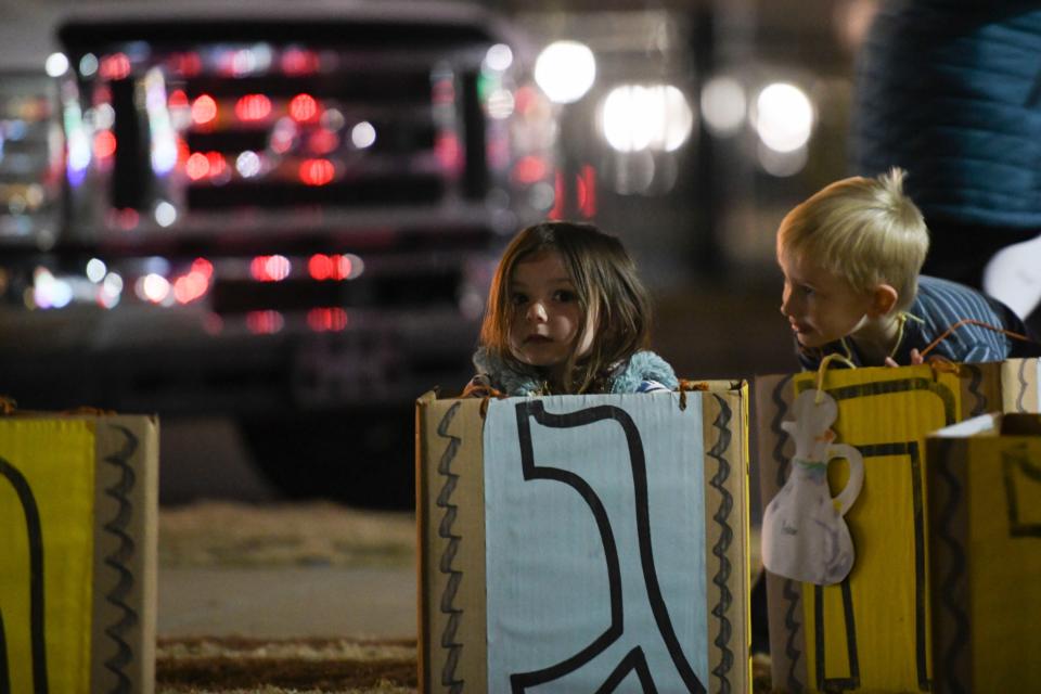 Miriam Miller, 4, kneels in a dreidel costume during the Chabad of Augusta's annual Chanukah ceremony and Grand Menorah Lighting in Evans Towne Center Park on Thursday, Dec. 7, 2023.