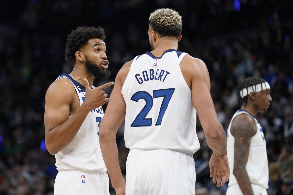 Minnesota Timberwolves center Karl-Anthony Towns, left, talks with center Rudy Gobert during the second half of the team's NBA basketball game against the Oklahoma City Thunder, Wednesday, Oct. 19, 2022, in Minneapolis. (AP Photo/Abbie Parr)