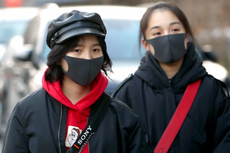 People wear protective masks in downtown Beijing on January 21, 2020, 11 days after the country reported its first known death from a novel coronavirus. File Photo by Stephen Shaver/UPI