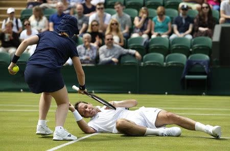 Britain Tennis - Wimbledon - All England Lawn Tennis & Croquet Club, Wimbledon, England - 28/6/16 Czech Republic's Radek Stepanek is helped up by a ball girl after slipping on court against Australia's Nick Kyrgios REUTERS/Andrew Couldridge