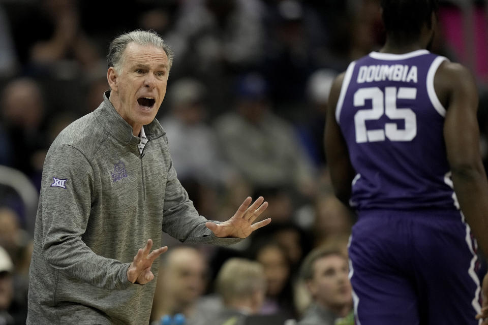 TCU head coach Jamie Dixon talk to center Souleymane Doumbia (25) during the second half of an NCAA college basketball game against Texas in the semifinal round of the Big 12 Conference tournament Friday, March 10, 2023, in Kansas City, Mo. (AP Photo/Charlie Riedel)