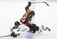 Montreal's Maureen Murphy (15) and Boston's Sophie Shirley (9) battle during second-period PWHL playoff hockey game action in Laval, Quebec, Saturday, May 11, 2024. (Christinne Muschi/The Canadian Press via AP)