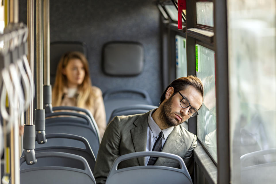 person asleep on the bus