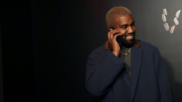 Rapper Kanye West talks on the phone before attending the Versace presentation in New York, U.S. December 2, 2018