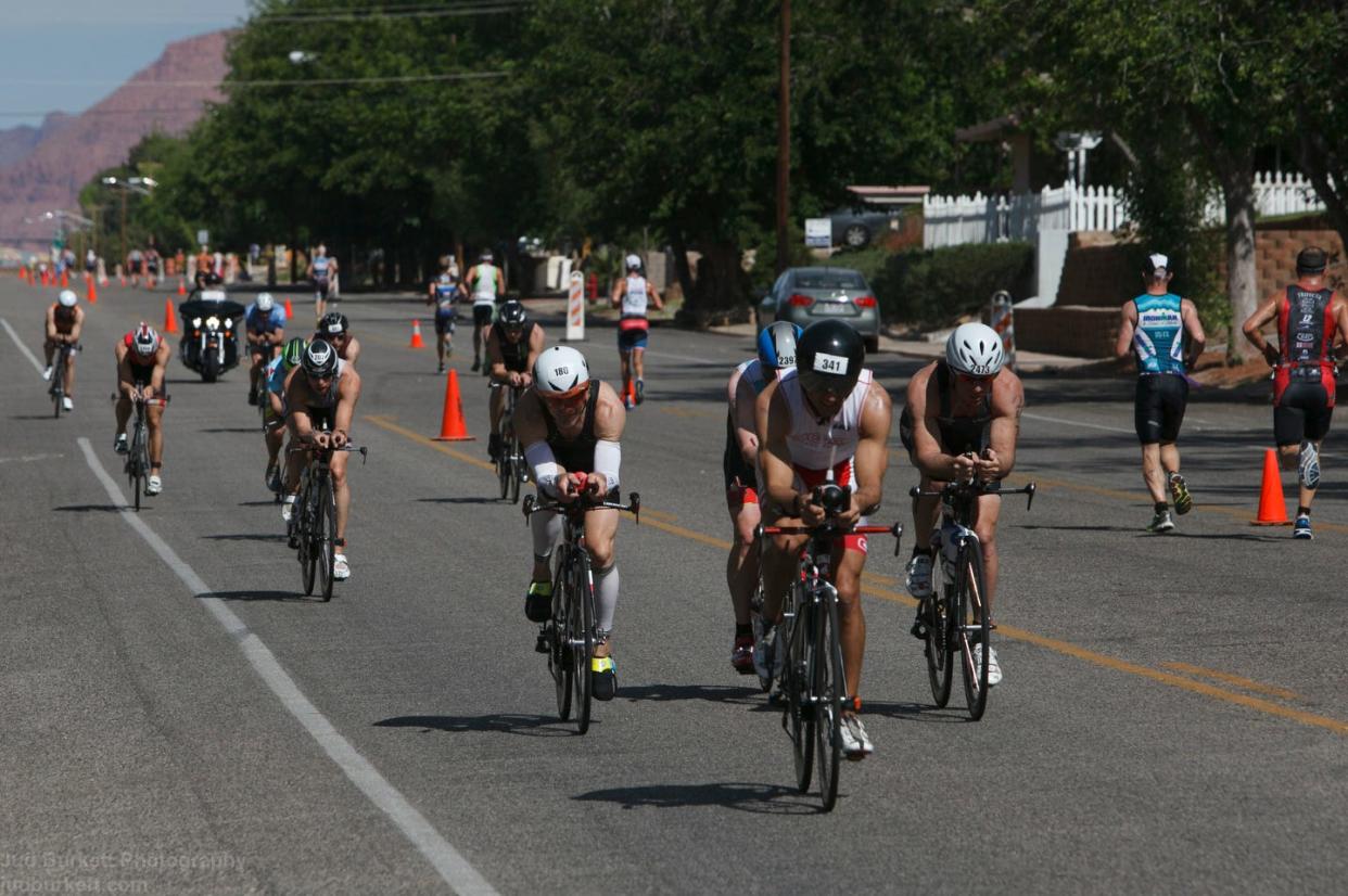 Participants in the St. George IRONMAN triathlon race. Two participants in the race on Saturday were injured when a driver allegedly ignored a traffic flagger and drove onto the race course.