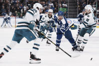 Toronto Maple Leafs' Auston Matthews tries to bring the puck through the San Jose Sharks' defense during the second period of an NHL hockey game Wednesday, Nov. 30, 2022, in Toronto. (Chris Young/The Canadian Press via AP)