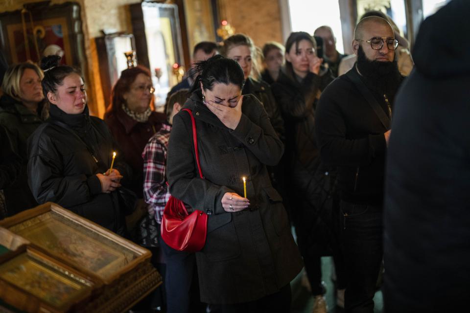 A woman cries during the funeral of Sofia Shulha, 11, and Pysarev Kiriusha, 17, in Uman, central Ukraine, Sunday, April 30, 2023. Shulha and Kiriusha were killed during a Russian attack on a residential building early Friday morning. | Bernat Armangue, Associated Press