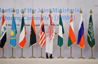 An employee adjusts the Mexican flag at the meeting room before the OPEC 14th Meeting of the Joint Ministerial Monitoring Committee in Jeddah, Saudi Arabia, May 19, 2019. REUTERS/Waleed Ali