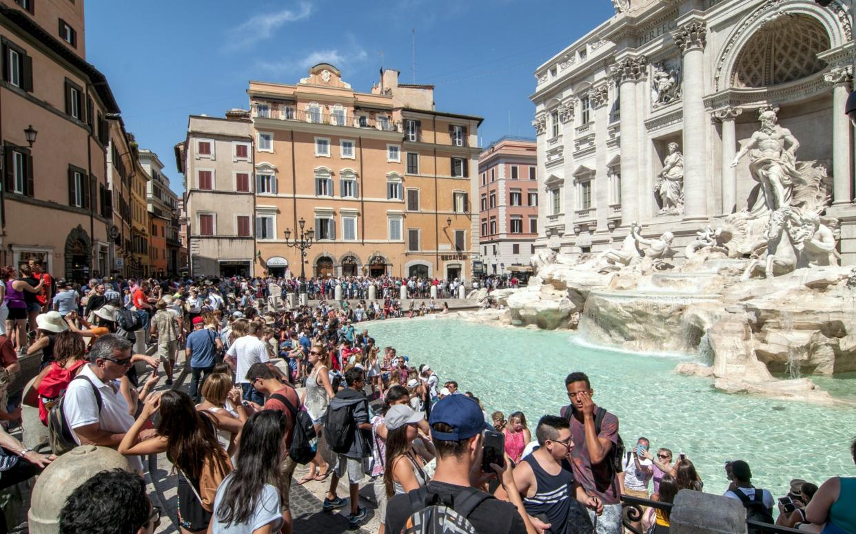 Nowadays the fountain, and the piazza in which it is located, is packed with tourists - LightRocket