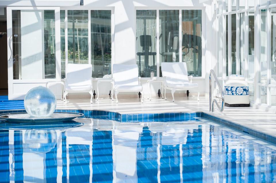a swimming pool with chairs around it