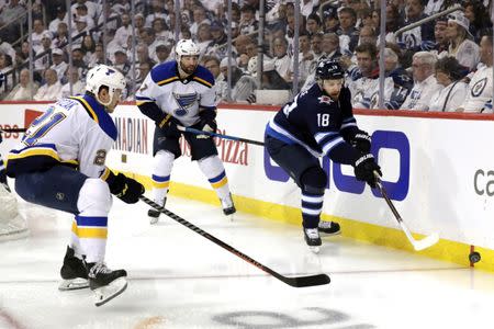 FILE PHOTO: Apr 18, 2019; Winnipeg, Manitoba, CAN; Winnipeg Jets center Bryan Little (18) and St. Louis Blues center Tyler Bozak (21) chase down the puck in the first period in game five of the first round of the 2019 Stanley Cup Playoffs at Bell MTS Place. Mandatory Credit: James Carey Lauder-USA TODAY Sports