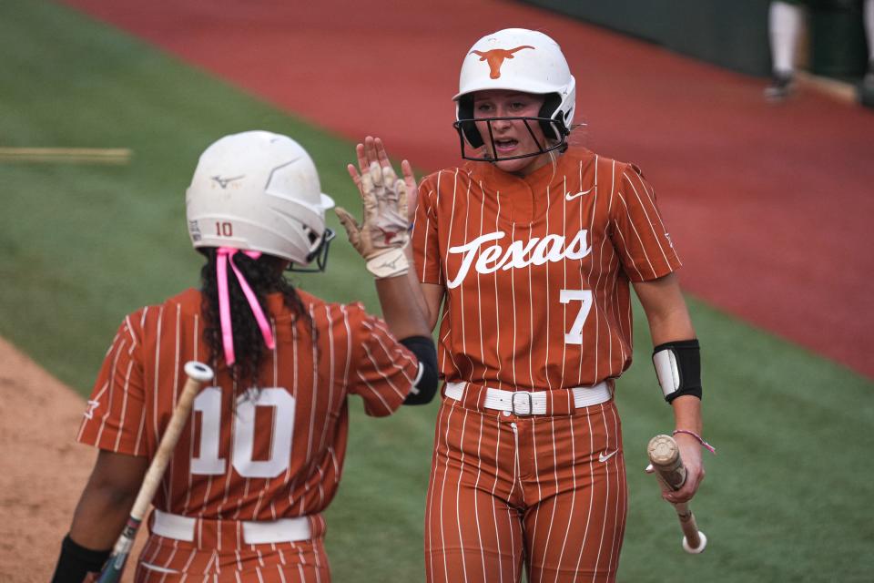 Texas Longhorns outfielder Ashton Maloney (7) celebrates a score with infielder Mia Scott (10) during the game against Baylor at Red & Charline McCombs Field on Friday, May 5, 2023 in Austin.