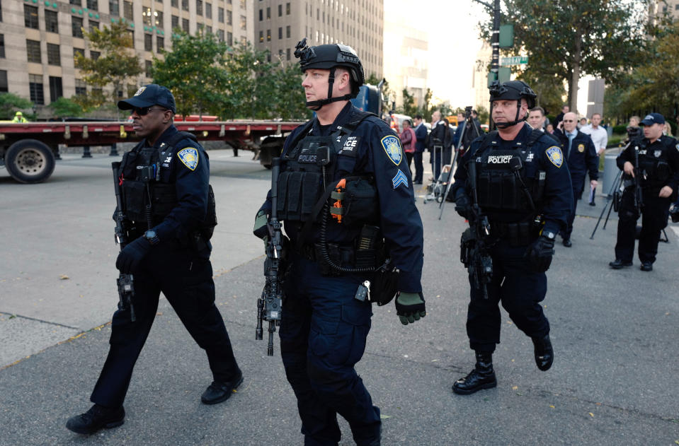 <p>New York Police Department officers gather near the scene after a motorist drove onto a busy bicycle path near the World Trade Center memorial and struck several people Tuesday, Oct. 31, 2017, in New York. (Photo: Mark Lennihan/AP) </p>