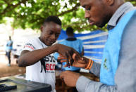 A man gets his finger inked after casting his vote at a polling station during a presidential run-off in Freetown, Sierra Leone March 31, 2018. REUTERS/Olivia Acland