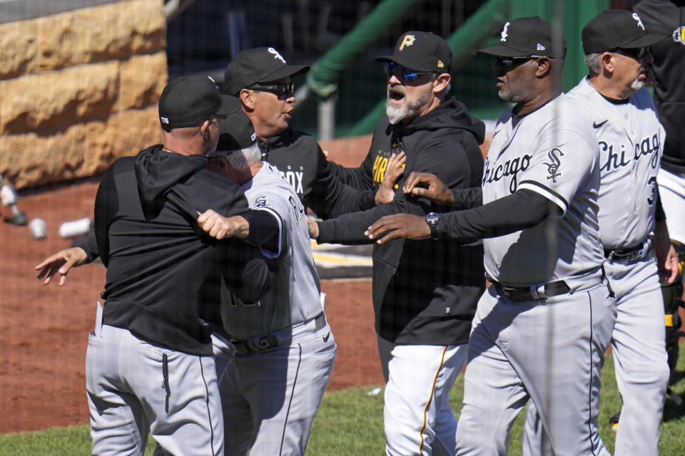 Chicago White Sox manager Pedro Grifol, left, and Pittsburgh Pirates manager Derek Shelton, right, are separated by coaches after the benchs cleared as a result of a home plate collision between Pittsburgh Pirates' Oneil Cruz, left, and Chicago White Sox catcher Seby Zavala during the sixth inning of a baseball game in Pittsburgh, Sunday, April 9, 2023. Cruz was injured on the play and helped off the field. The Pirates won 1-0. (AP Photo/Gene J. Puskar)