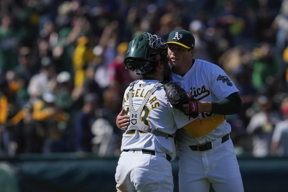 Oakland Athletics pitcher Mason Miller, right, hugs catcher Shea Langeliers after their victory over the Washington Nationals in a baseball game Sunday, April 14, 2024, in Oakland, Calif. (AP Photo/Godofredo A. Vásquez)